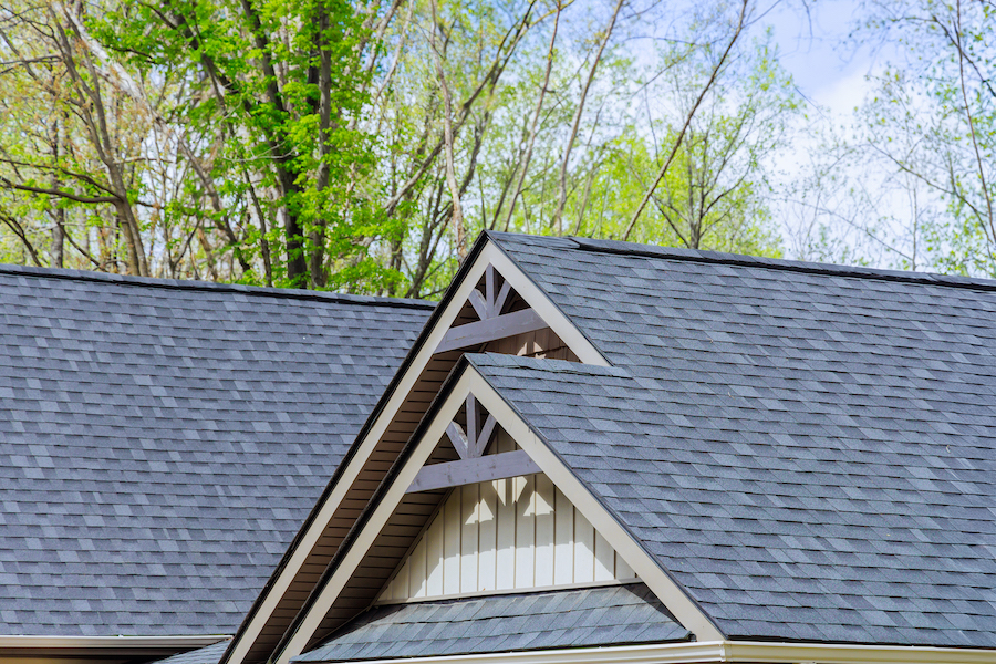 Grey rooftop shingles covering a newly constructed home