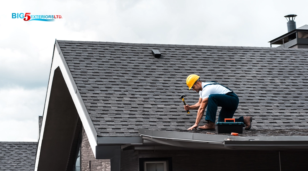 Warranty worker on roof repairing shingles