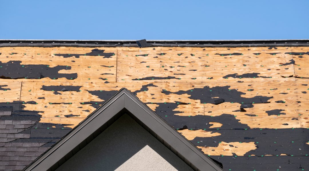 A weather-damaged roof with severe shingle loss.